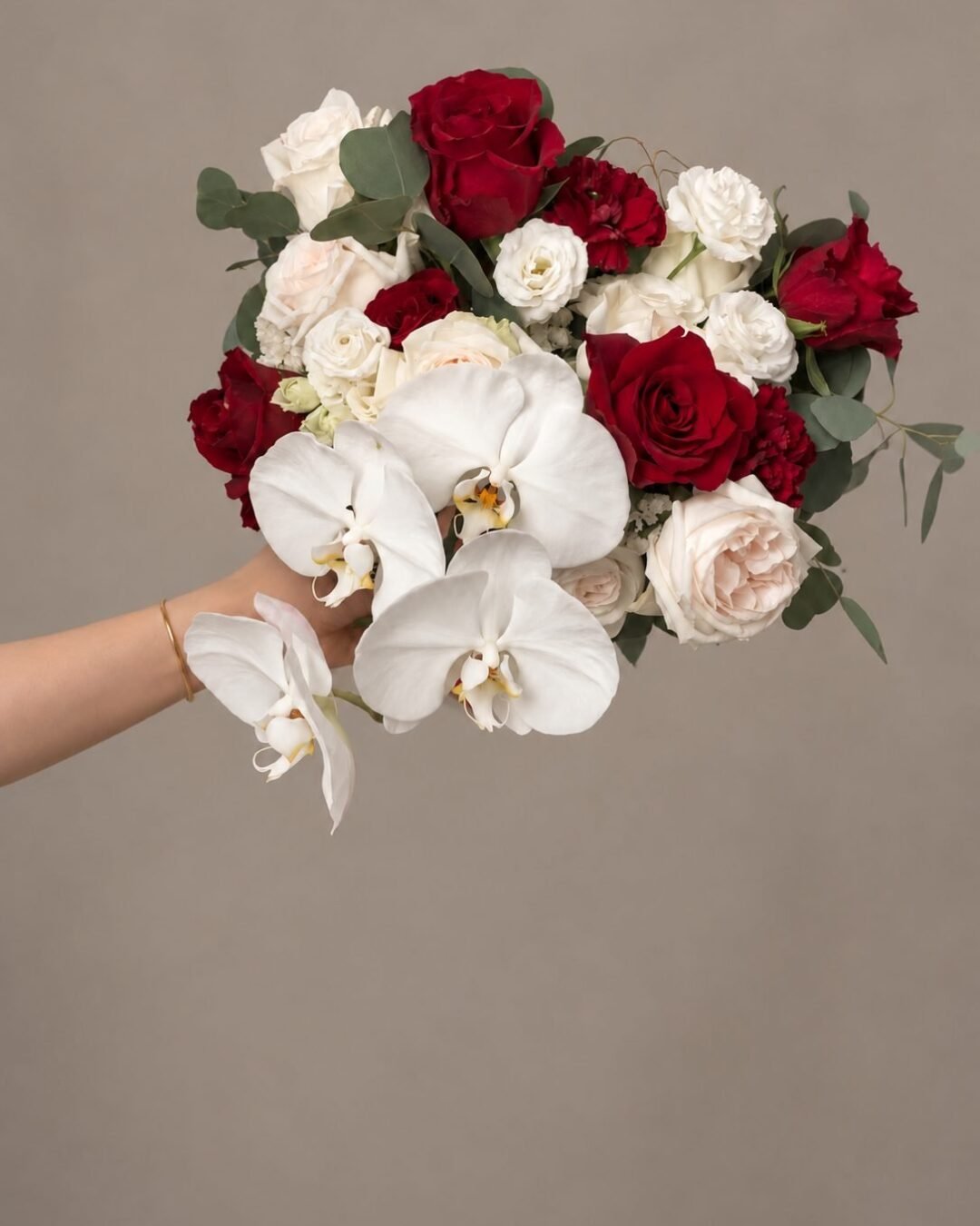 Berlin dramatic · asymmetrical bridal bouquet in crimson, blush, ivory and deep green