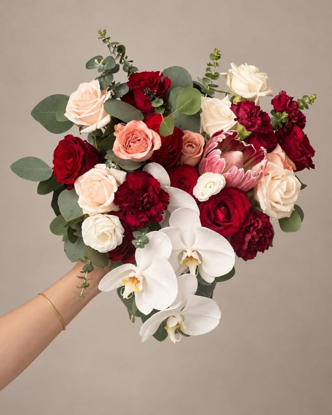 Danessa dramatic · asymmetrical bridal bouquet in crimson, blush, ivory and deep green