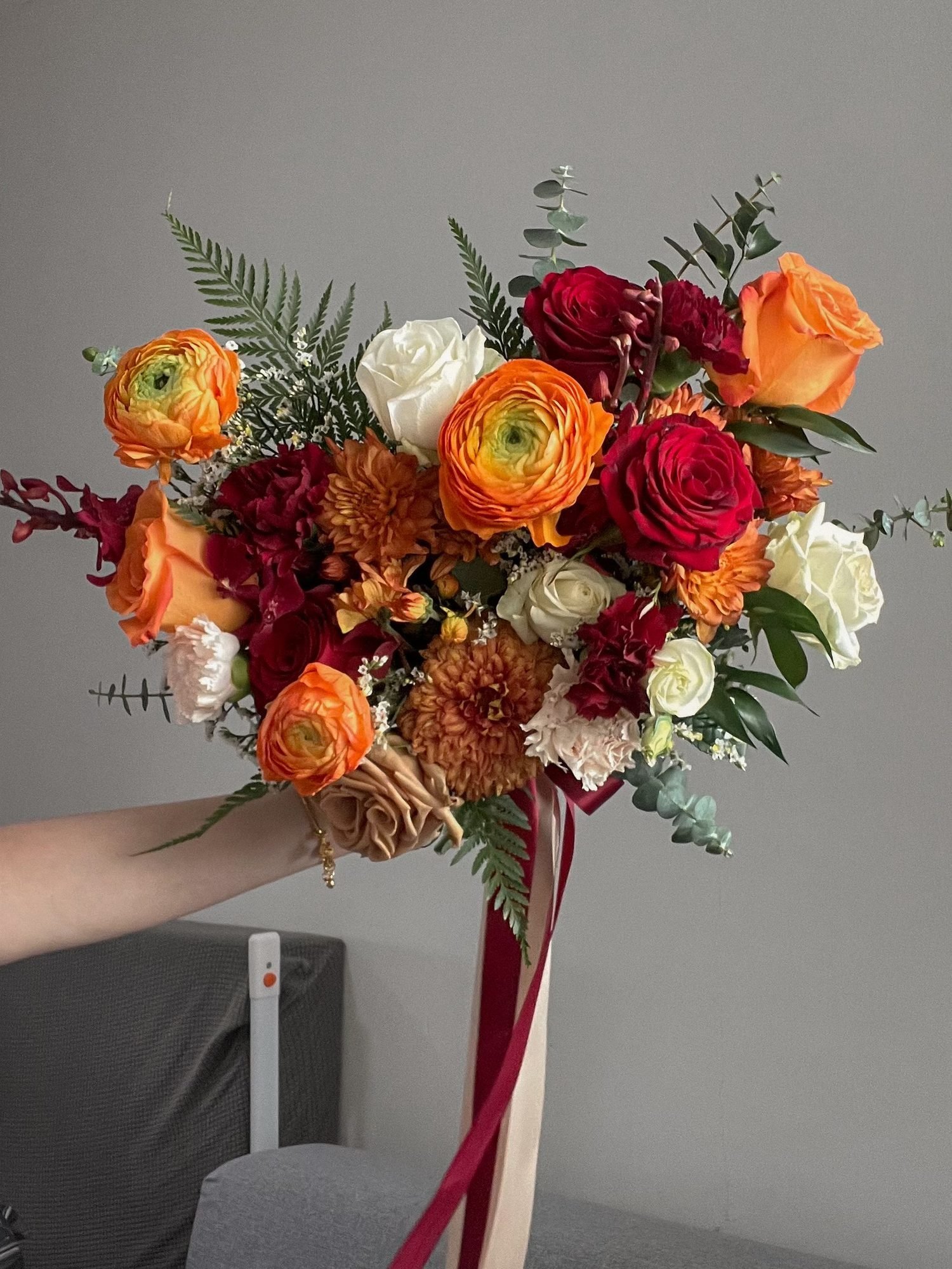 Liz dramatic · asymmetrical bridal bouquet in tangerine, crimson, blush, ivory and sage — alternate view