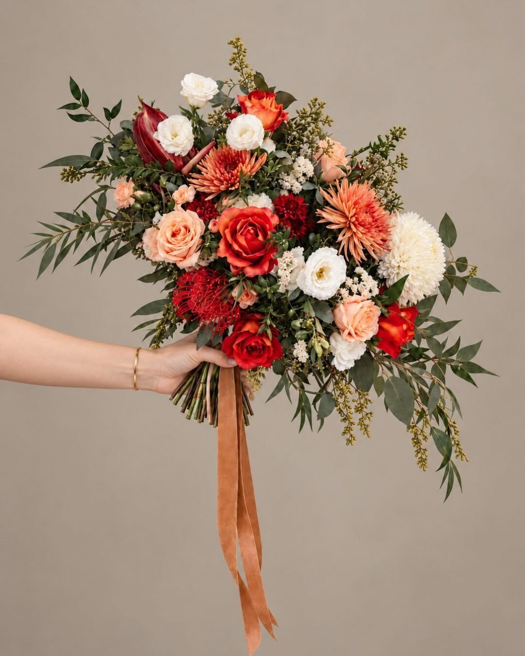 Rei dramatic · cascading bridal bouquet in crimson, burnt orange, blush, ivory and eucalyptus