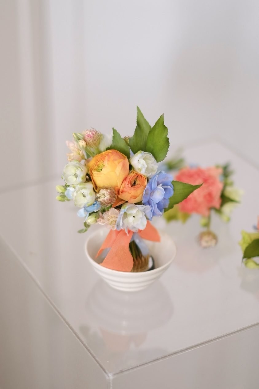Summer dramatic · cascading bridal bouquet in tangerine, dusty blue, ivory, crimson and blush — alternate view