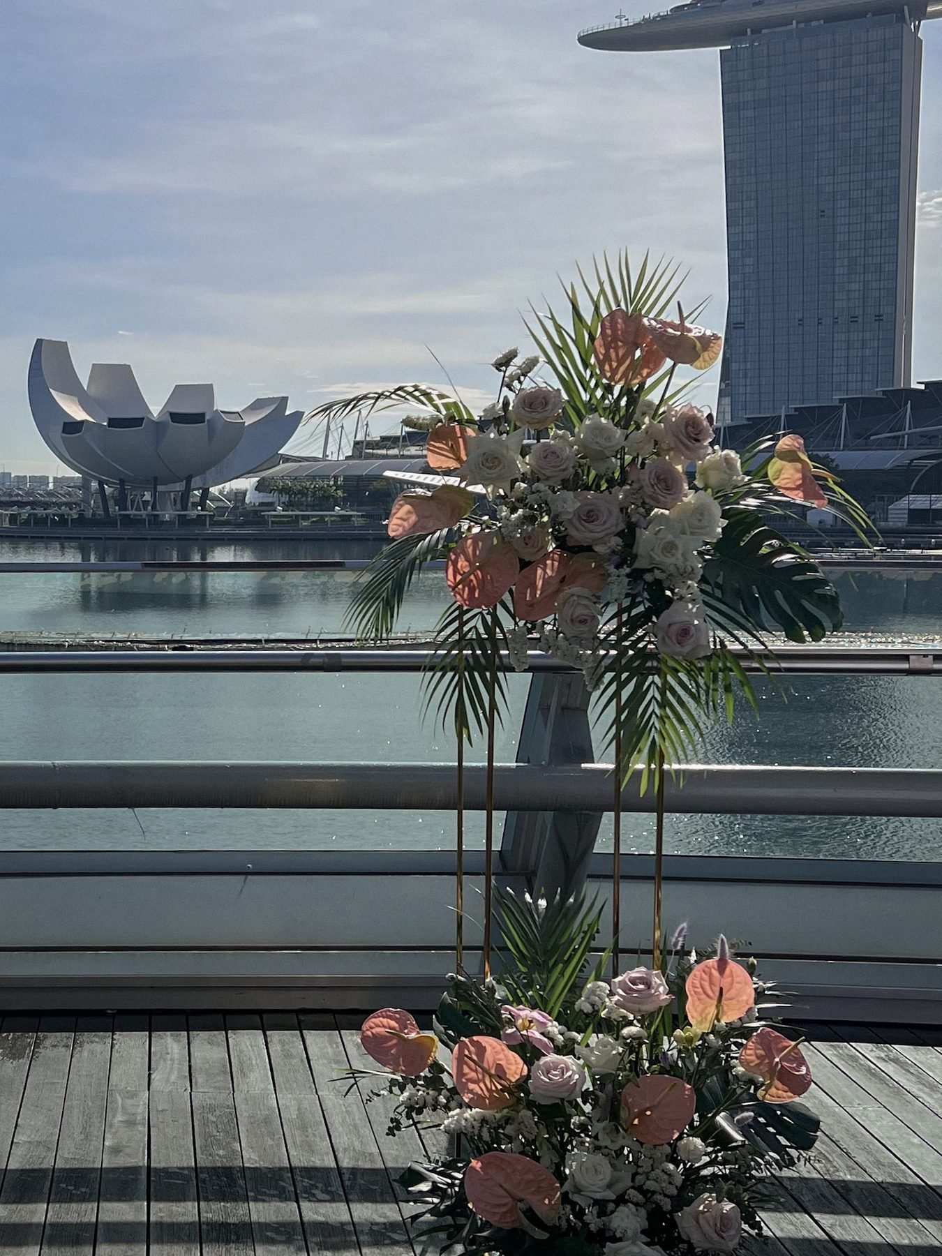 Blush and ivory standing floral arrangement and floor cluster by the bay skyline