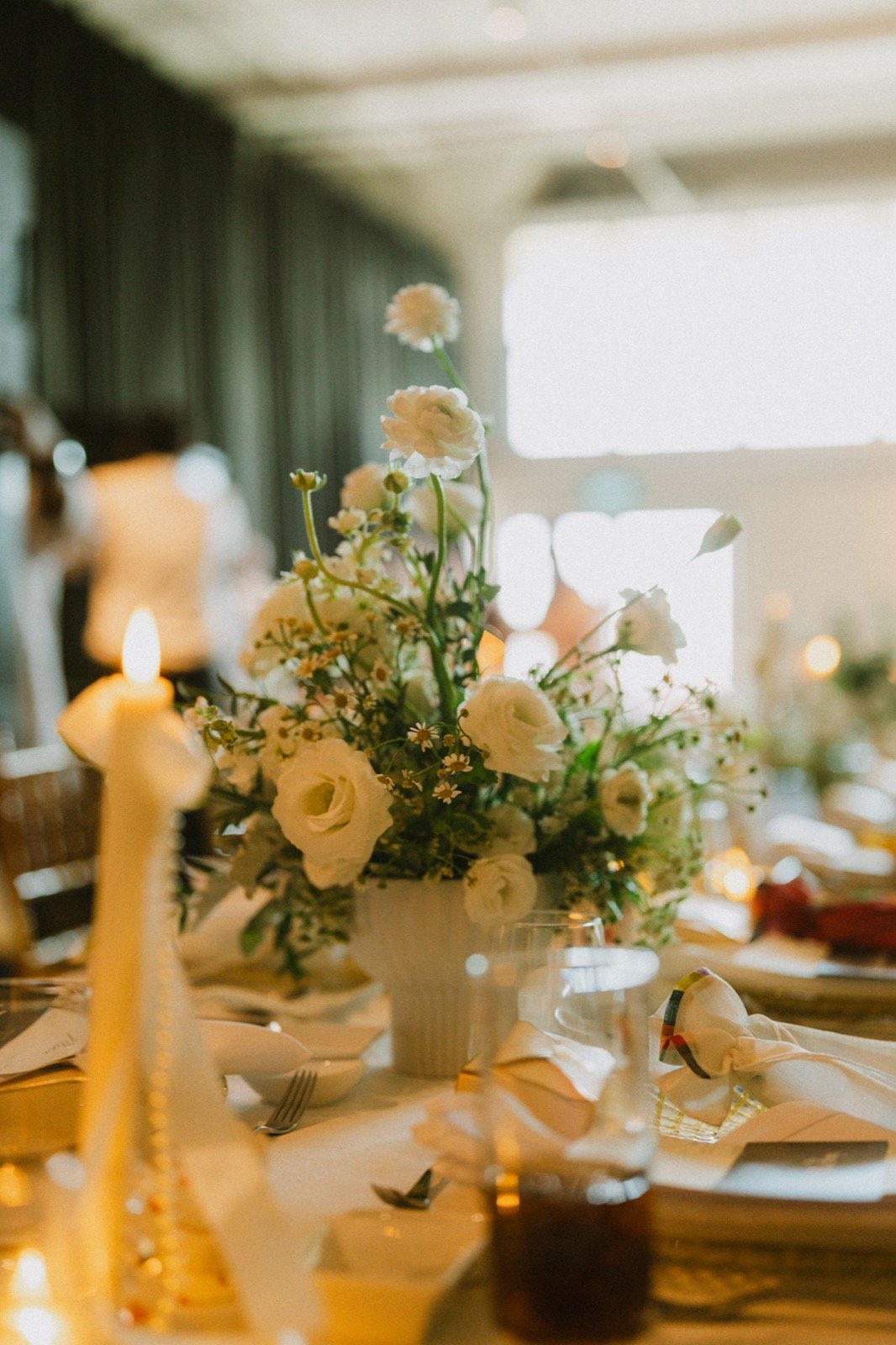 White reception flowers in candlelight