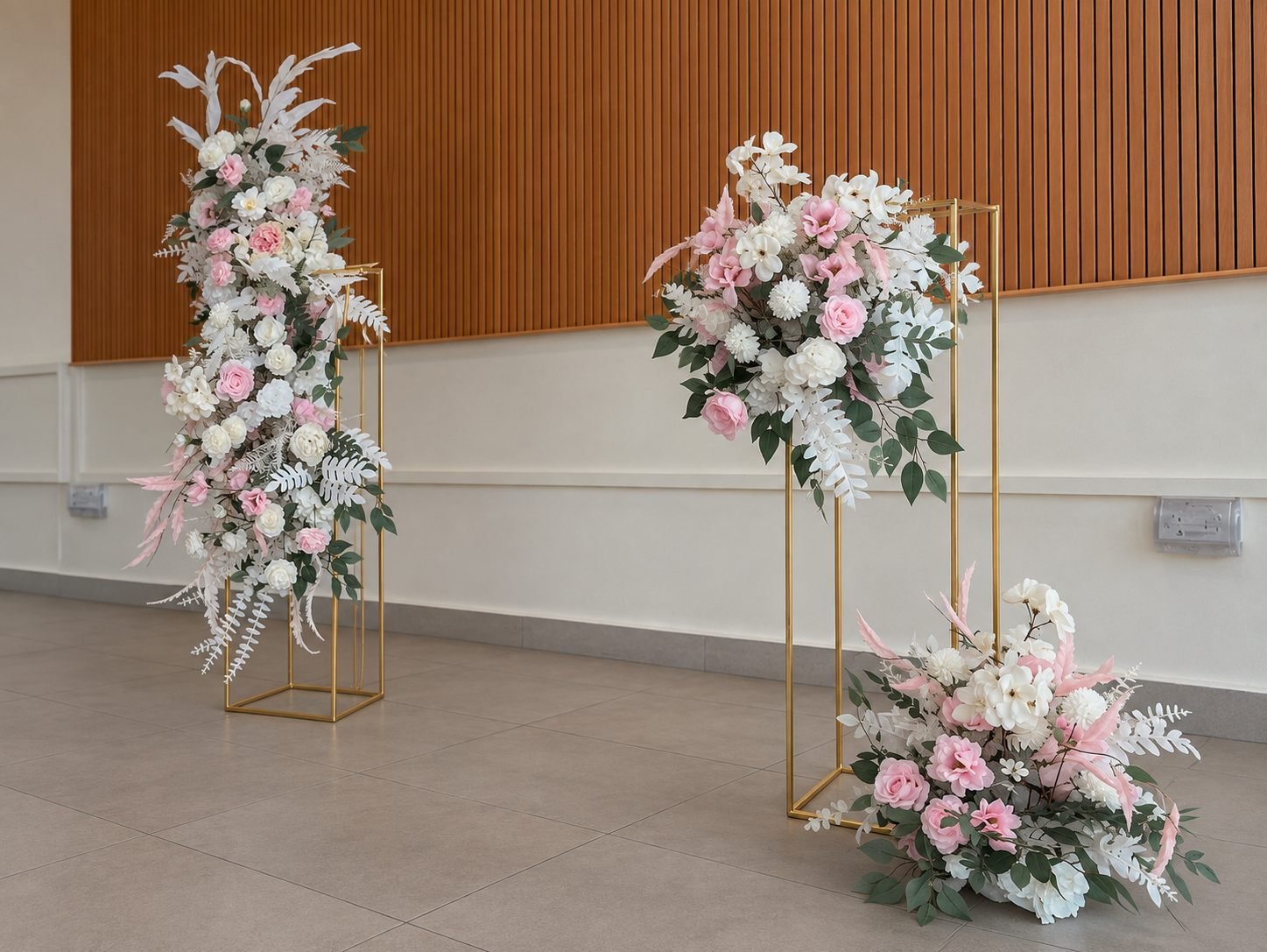 Gold frame ceremony set with blush and white arrangements seen from the side